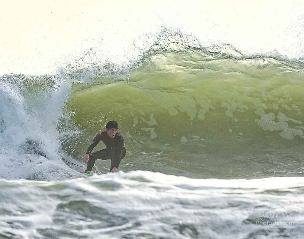 Photo passant devant une grosse vague